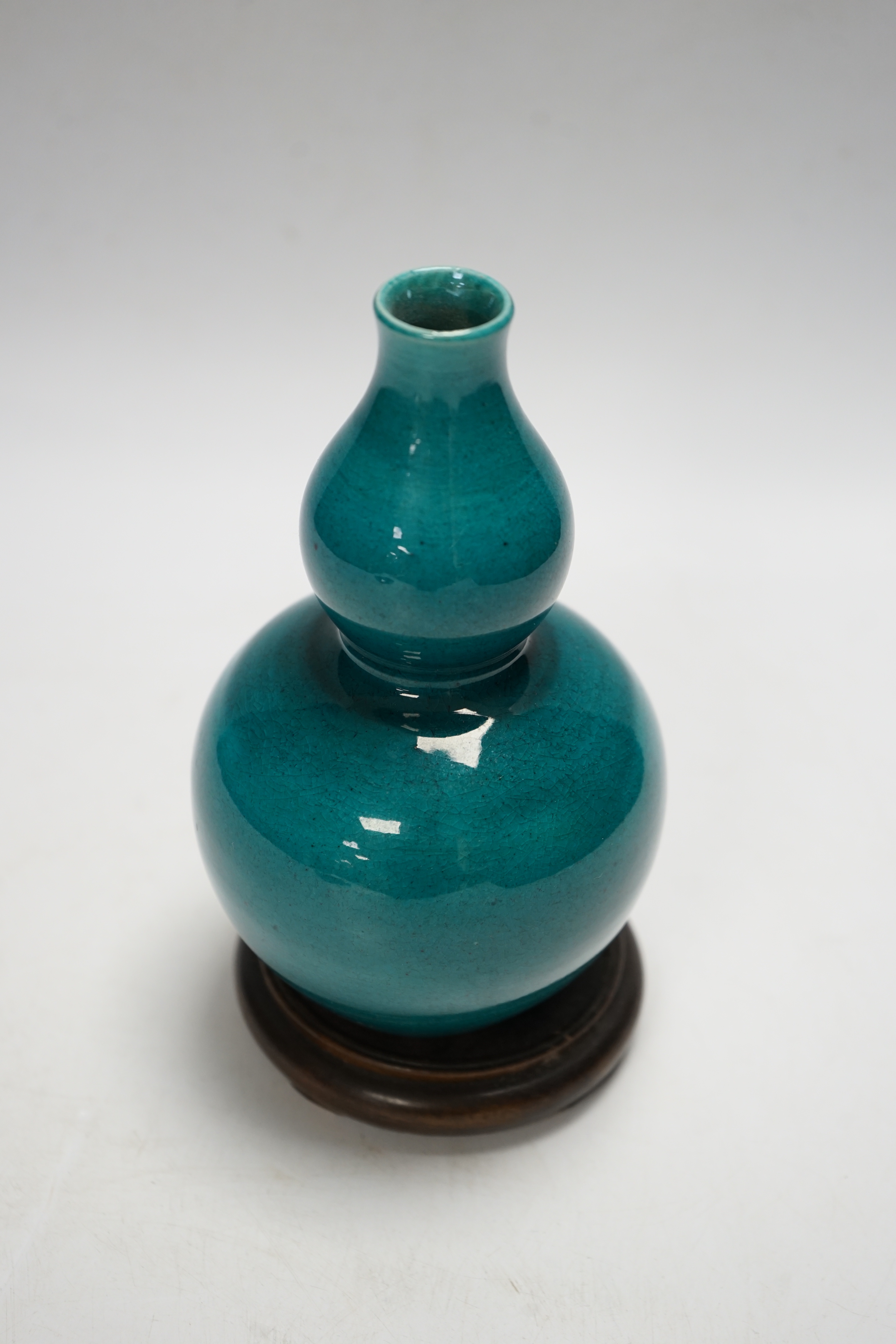 A Chinese turquoise glazed double gourd vase, on stand, 17cm